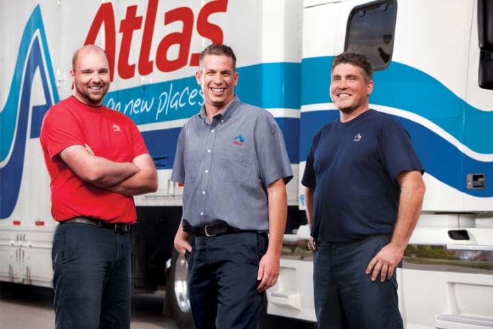 Evergreen Moving Systems team members in front of an Atlas vehicle