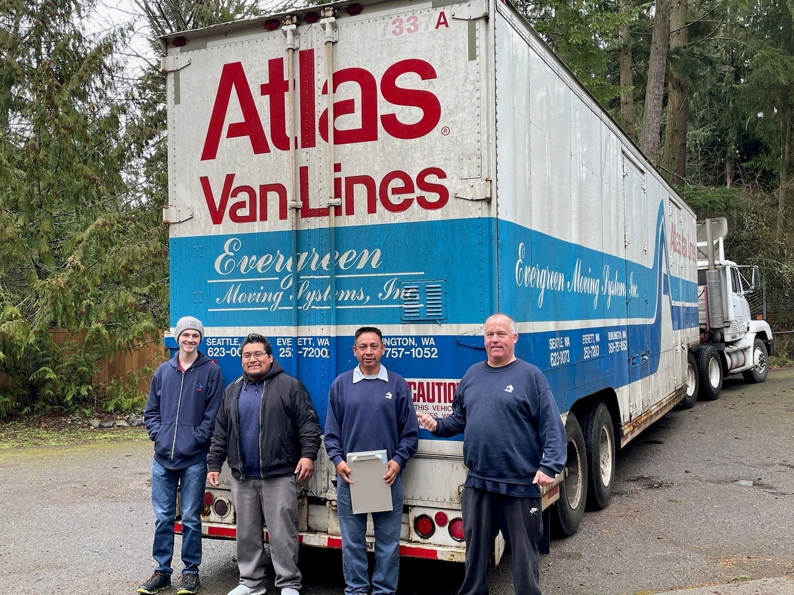 Evergreen Moving Systems team standing by an Atlas Van Lines truck